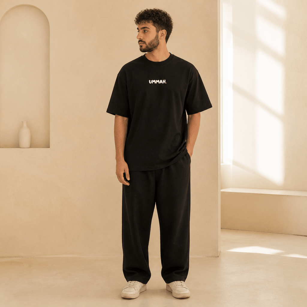 Man wearing the Hardship Comes Ease Black T-shirt, front view - Ummah Collective